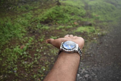 High angle view of human hand against blurred background