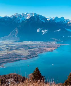 Scenic view of snowcapped mountains against blue sky