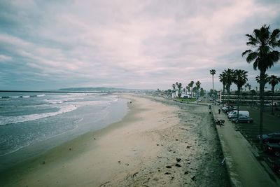 View of beach against cloudy sky