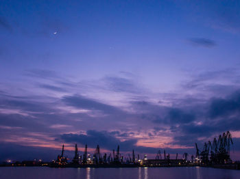 Harbor against sky at night