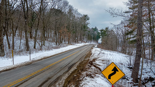 Road amidst trees in forest