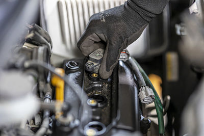 Cropped hand of man repairing car