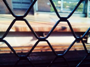 Close-up of chainlink fence against sky