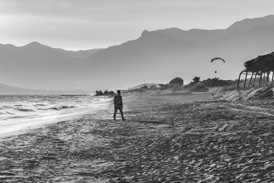 Man standing on beach against sky