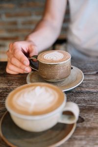 Close-up of hand holding coffee cup