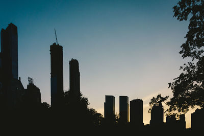 Silhouette buildings against sky during sunset