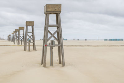 Lifeguard hut on beach against sky