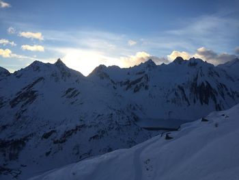 Scenic view of snow covered mountains against sky