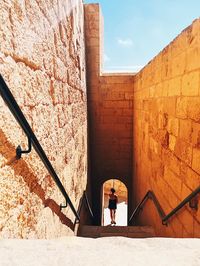 High angle view of mid adult woman moving up on steps