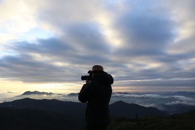 Scenic view of mountains against cloudy sky