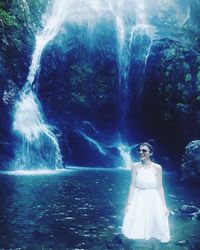 Digital composite image of woman standing by sea