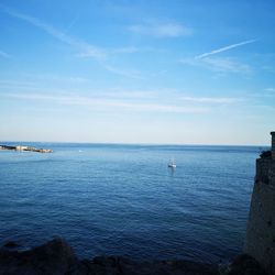 Scenic view of sea against blue sky