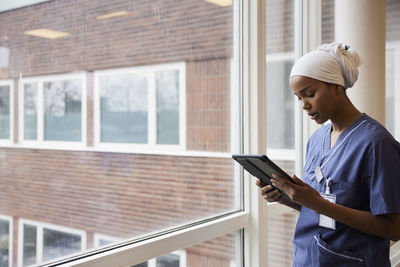 Young female doctor using tablet at work