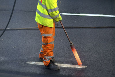 Low section of man working on road