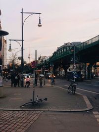 People on street in city at sunset