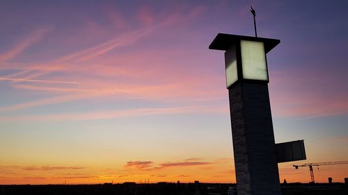 Low angle view of silhouette building against sky during sunset