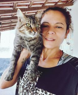 Portrait of young woman with cat