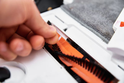 Repair robot vacuum cleaner, close up. household appliance service