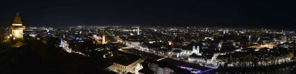 City lights of graz and the famous clock tower on shlossberg hill  styria region austria by night