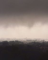 Cityscape against cloudy sky