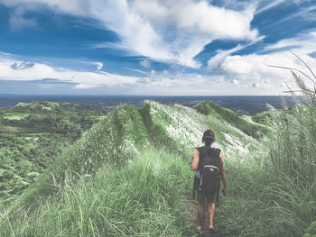 Rear view of person on land against sky