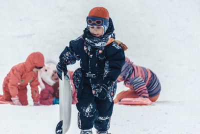 Full length of father and son standing on snow