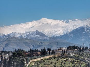 Scenic view of snow covered mountain against cloudy sky