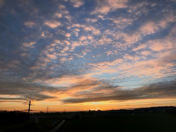 Scenic view of dramatic sky over silhouette landscape