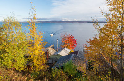 High angle view of trees by lake against sky during autumn