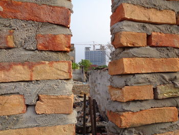 Close-up of brick wall against building