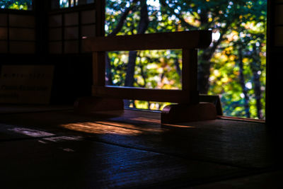 Close-up of window on wooden table against building