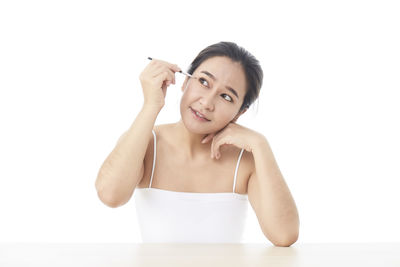 Portrait of a beautiful young woman over white background