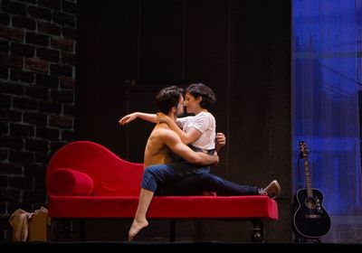 Young couple sitting on wall