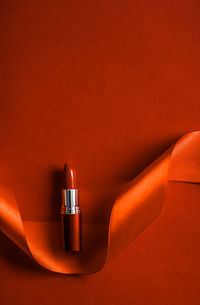 High angle view of lipstick on red background