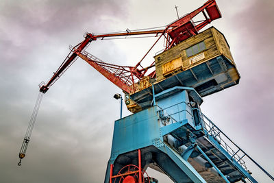 Low angle view of crane against sky