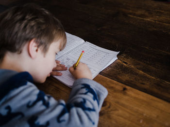 High angle portrait of boy holding table