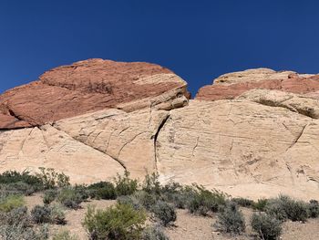 Rock formations in desert against clear blue sky