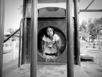 Portrait of girl playing in jungle gym at playground