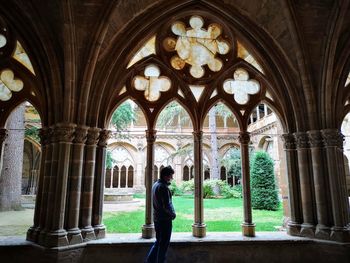 Rear view of man walking in historic building