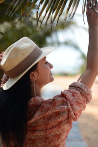 Close-up of young woman wearing hat