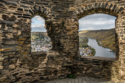 Town and river seen through old ruin window