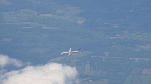 Aerial view of aircraft wing against sky