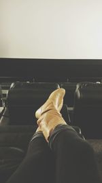 Rear view of a young man sitting on bench