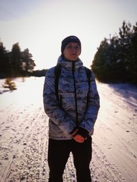 Portrait of man standing in snow