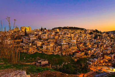 High angle shot of townscape against sky at sunset