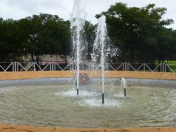 Fountain in park against sky