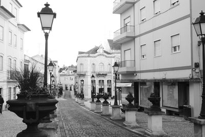 Street lights in city against sky