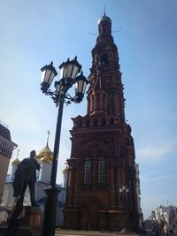 Low angle view of statue in city against sky