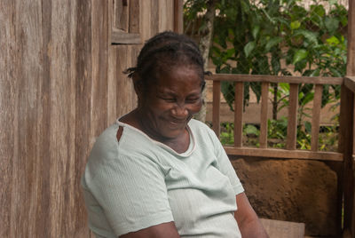 Woman standing by railing against blurred background