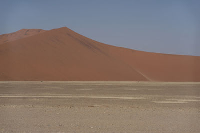 Scenic view of mountains against clear blue sky